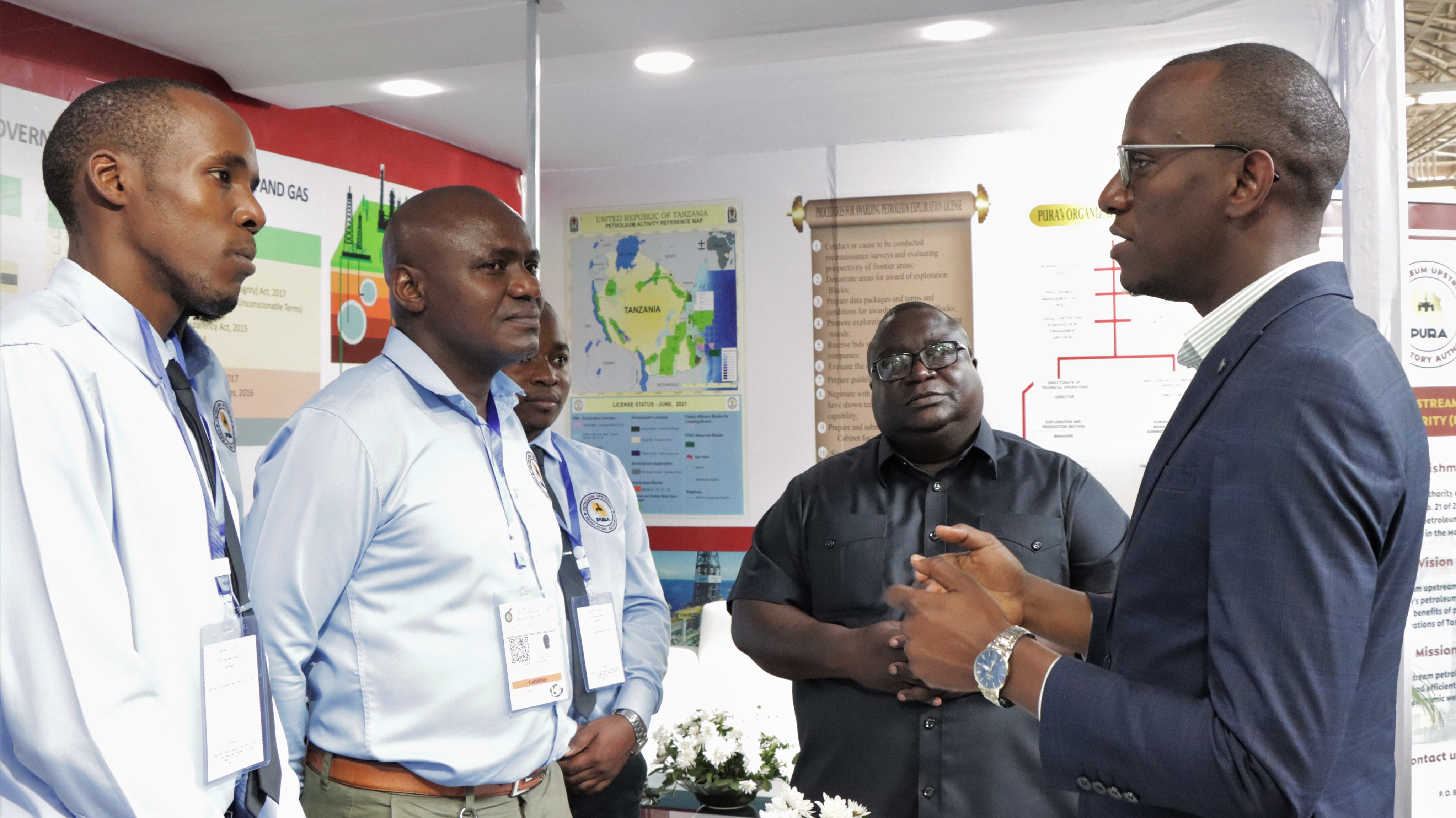 Deputy Minister of Energy Stephen Byabato talking to PURA officials, during his visit to the Authority's pavilion at the 45th International Trade Fair (Sabasaba) 2021 which takes place at Sabasaba grounds.